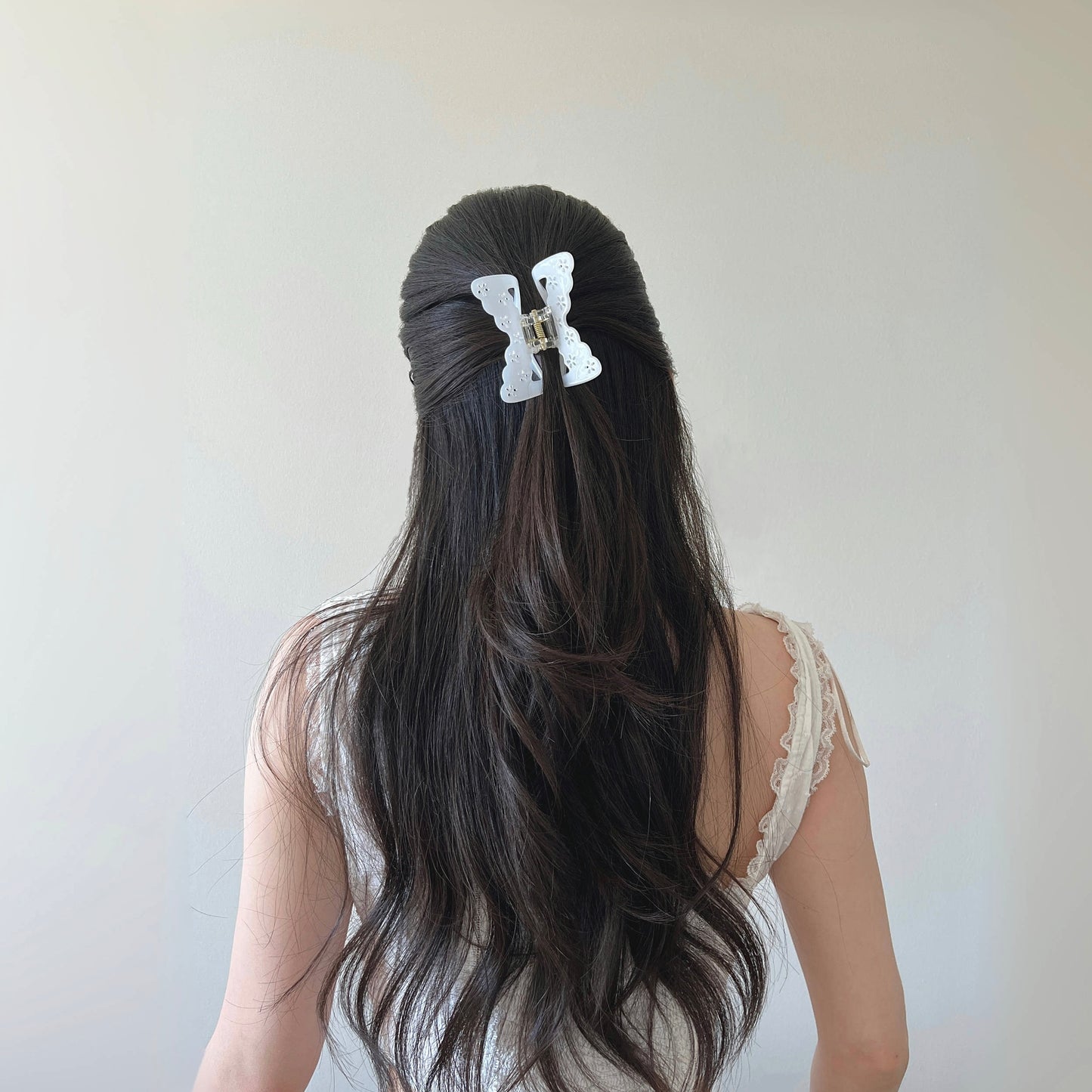 girl-in-butterfly-claw-pearl-halfup-hairstyle