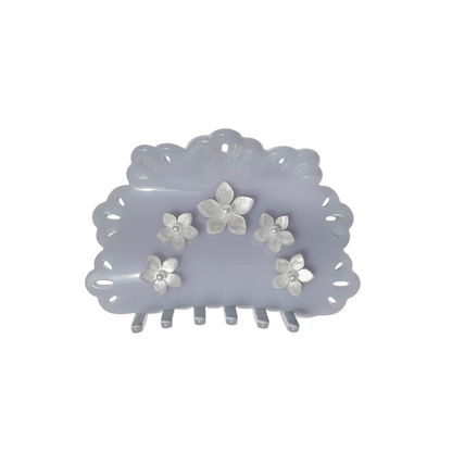 Lavendar gray hair claw clip with floral designs on a white background