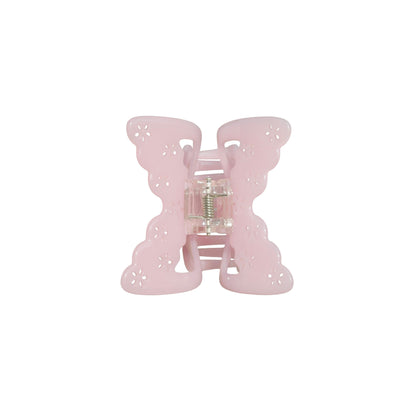 Pink butterfly-shaped hair claw clip on a white background