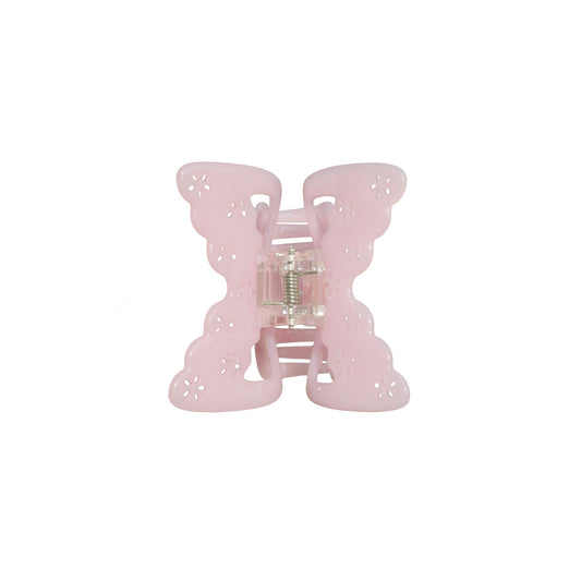 Pink butterfly-shaped hair claw clip on a white background