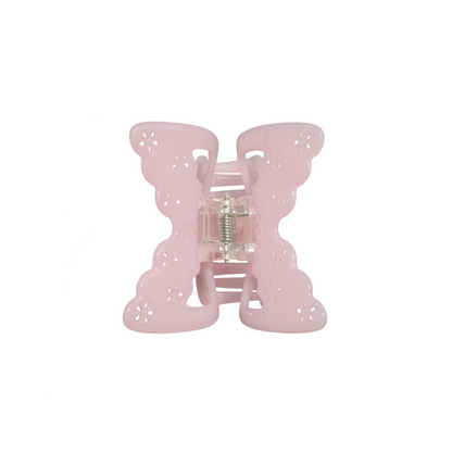 Pink butterfly-shaped hair claw clip on a white background