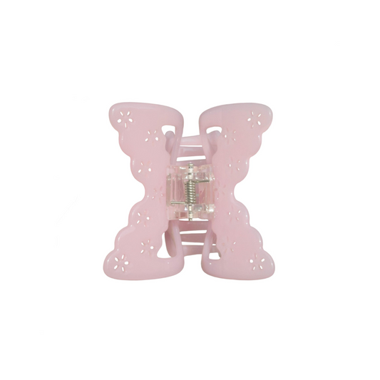 Pink butterfly-shaped hair claw clip on a white background