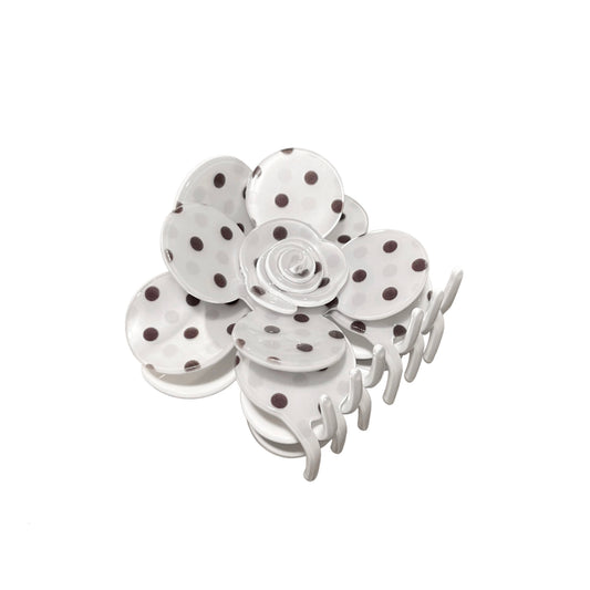 White flower hair claw clip with polka dot design on a white background